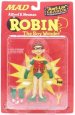 The world needs heroes! Unfortunately, the best we can do is MAD MAGAZINE's own gap-toothed idiot masquerading as Batman's trusty sidekick Robin! Battling The Joker is gonna be the least of Batman's worries with this hero fighting at his side! This moronic action figure features multiple points of articulation, stands approximately 6.125 tall, features a cloth cape and comes packaged with a slingshot and a lollipop emblazoned with the Bat-signal. Packaged in a 4-color blister.